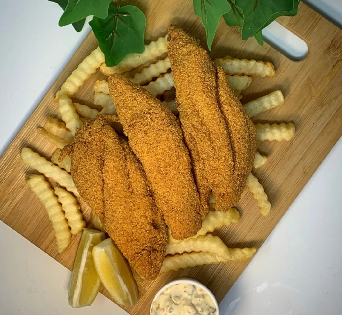 Mandy’s cornmeal-battered fish fillets with crinkle fries, lemon and tartar sauce