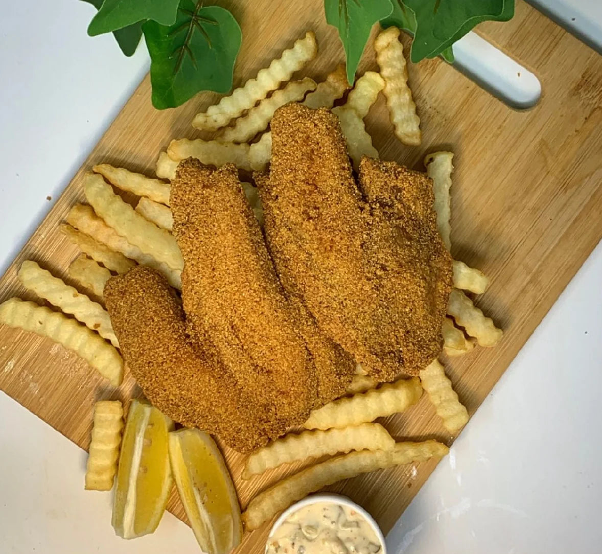 A board of Mandy’s fried fish and crinkle fries